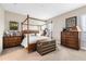 Bedroom featuring a four poster bed, decorative chest, and matching dressers at 18405 Mowry Ct, Orlando, FL 32827