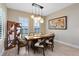 Formal dining area with decorative light fixture and plenty of natural lighting at 18405 Mowry Ct, Orlando, FL 32827