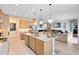 Open kitchen layout with an island, stainless steel appliances, and seamless flow into the living area at 18405 Mowry Ct, Orlando, FL 32827