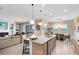 Open kitchen, dining, and living space with granite countertops and stainless steel appliances at 18405 Mowry Ct, Orlando, FL 32827
