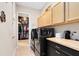 This laundry room features modern appliances, ample counter space, and leads into a well-organized closet at 18405 Mowry Ct, Orlando, FL 32827