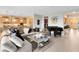 Open-concept floor plan featuring a living room, grand piano, and access to the kitchen at 18405 Mowry Ct, Orlando, FL 32827