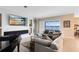 Bright living room with a modern fireplace, view of the water, and a comfortable seating area at 18405 Mowry Ct, Orlando, FL 32827