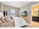 Cozy main bedroom with a large window, natural light, and an en-suite bathroom at 18405 Mowry Ct, Orlando, FL 32827