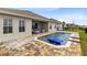 Beautiful backyard pool with brick paver patio and outdoor seating area at 18405 Mowry Ct, Orlando, FL 32827