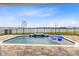 Backyard pool overlooking lake, waterfall feature, blue lounge chairs and brick pavers at 18405 Mowry Ct, Orlando, FL 32827