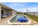 Backyard pool with lake view, waterfall feature, lounge chairs, outdoor seating, and patio at 18405 Mowry Ct, Orlando, FL 32827