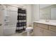 Bathroom featuring a shower-tub combo, toilet, tile backsplash, and gray vanity with white countertop at 1972 Spring Shower Cir, Kissimmee, FL 34744
