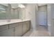 Bathroom featuring a double vanity, modern lighting, and wood-look tile flooring at 1972 Spring Shower Cir, Kissimmee, FL 34744