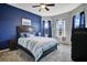 Spacious bedroom featuring a dark accent wall, a comfortable king-size bed, and natural light from large windows at 1972 Spring Shower Cir, Kissimmee, FL 34744