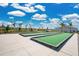 Well-maintained bocce ball courts with lush green surfaces surrounded by serene landscaping and clear blue skies at 1972 Spring Shower Cir, Kissimmee, FL 34744