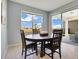 Cozy dining area with views of the backyard through large windows and sliding glass doors at 1972 Spring Shower Cir, Kissimmee, FL 34744