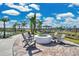Inviting community fire pit area with comfortable seating and lush landscaping, perfect for outdoor gatherings at 1972 Spring Shower Cir, Kissimmee, FL 34744