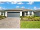 Charming single Gathering home with stone accents, a two-car garage, and a well-maintained front yard at 1972 Spring Shower Cir, Kissimmee, FL 34744