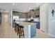 Modern kitchen with stainless steel appliances, large center island with seating, and recessed lighting at 1972 Spring Shower Cir, Kissimmee, FL 34744