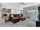 Inviting open-concept living room featuring wood-look floors, a ceiling fan, and large windows at 1972 Spring Shower Cir, Kissimmee, FL 34744