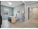 Modern office space featuring a white desk, chair, and shelf, along with hardwood flooring and a light blue accent wall at 1972 Spring Shower Cir, Kissimmee, FL 34744