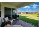 Back patio featuring stone pavers, seating, grill, and views of the expansive green lawn and neighborhood at 1972 Spring Shower Cir, Kissimmee, FL 34744