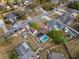 Neighborhood aerial view featuring lush landscaping, long driveways, and a home with solar panels at 2531 Ludlow St, Deltona, FL 32738