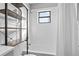 Bathroom with tub, shower, grey vanity, and shelving unit at 2531 Ludlow St, Deltona, FL 32738