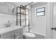 Bathroom with tub, shower, grey vanity, and shelving unit at 2531 Ludlow St, Deltona, FL 32738