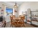 Charming dining room featuring a wooden table, ample natural light, and shelving unit at 2531 Ludlow St, Deltona, FL 32738