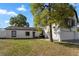 Inviting home with a manicured lawn and mature tree, complemented by a white fence for added privacy at 2531 Ludlow St, Deltona, FL 32738