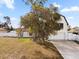 Charming home featuring white siding, an attached two-car garage, and a well-maintained front yard with mature trees at 2531 Ludlow St, Deltona, FL 32738