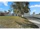 Charming home featuring white siding, an attached two-car garage, and a well-maintained front yard with mature trees at 2531 Ludlow St, Deltona, FL 32738