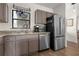 Kitchen boasts stainless steel appliances, granite countertops, and wood-look flooring at 2531 Ludlow St, Deltona, FL 32738