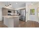 Spacious kitchen with granite countertops, stainless steel appliances, island, and wooden floors at 2531 Ludlow St, Deltona, FL 32738