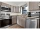 Cozy kitchen features stainless steel appliances, granite countertops, and wood-look flooring at 2531 Ludlow St, Deltona, FL 32738