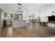 Open-concept living space features wood floors, kitchen island, and easy access to the dining area at 2531 Ludlow St, Deltona, FL 32738