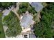 Aerial view of a single-story home with mature trees and a detached garage, highlighting the property layout at 265 W Constance Rd, Debary, FL 32713