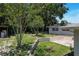 The backyard features lush greenery with mature trees and a well manicured landscape at 265 W Constance Rd, Debary, FL 32713