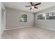 Neutral bedroom featuring tile floors, a ceiling fan, and multiple windows at 265 W Constance Rd, Debary, FL 32713