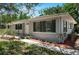 Charming single-story home with a well-manicured front yard, walkway and a gray exterior at 265 W Constance Rd, Debary, FL 32713