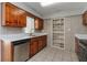 Cozy kitchen with wood cabinetry, tile backsplash, stainless steel dishwasher and quartz countertops at 265 W Constance Rd, Debary, FL 32713