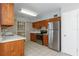 Traditional eat-in kitchen features wood cabinets, stainless steel appliances, and tile flooring at 265 W Constance Rd, Debary, FL 32713