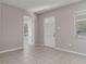 Living room with tile flooring, paneled walls and views into other rooms of the house at 265 W Constance Rd, Debary, FL 32713