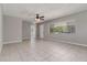 A spacious living room with tile flooring, a ceiling fan, and plenty of natural light at 265 W Constance Rd, Debary, FL 32713