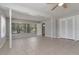 Open living room with tile floors, ceiling fan, and large windows at 265 W Constance Rd, Debary, FL 32713