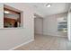Open living space with tile floors and a pass-through to the kitchen at 265 W Constance Rd, Debary, FL 32713