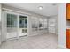 Bright sunroom features large windows, tile flooring, and access to the backyard at 265 W Constance Rd, Debary, FL 32713