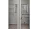 View of the utility room featuring access to plumbing, storage shelving and a window at 265 W Constance Rd, Debary, FL 32713