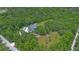Expansive aerial shot of a well-kept home nestled in a lush green landscape, with a large driveway at 2650 Howard Ave, Oviedo, FL 32765