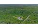 Aerial view of a house surrounded by lush green trees with a map pin indicating the property location at 2650 Howard Ave, Oviedo, FL 32765