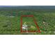 Aerial view of a property, outlining the lot lines in red, surrounded by dense forestry at 2650 Howard Ave, Oviedo, FL 32765