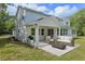 Spacious backyard featuring a covered patio area with outdoor furniture, including a fire pit, and a well-manicured lawn at 2650 Howard Ave, Oviedo, FL 32765