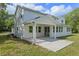 Spacious backyard featuring a covered patio area with supporting posts and a well-manicured lawn at 2650 Howard Ave, Oviedo, FL 32765